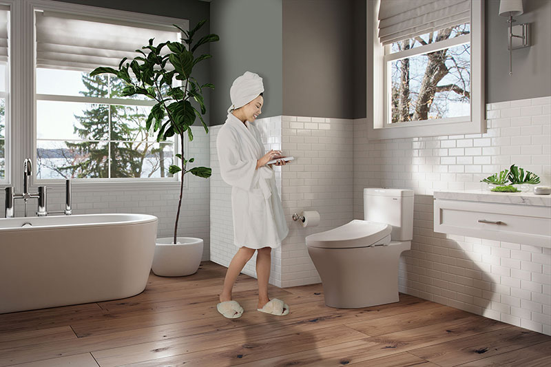 Woman in modern bathroom featuring a TOTO WASHLET K300, designed for women’s ultimate hygiene, comfort, and style.