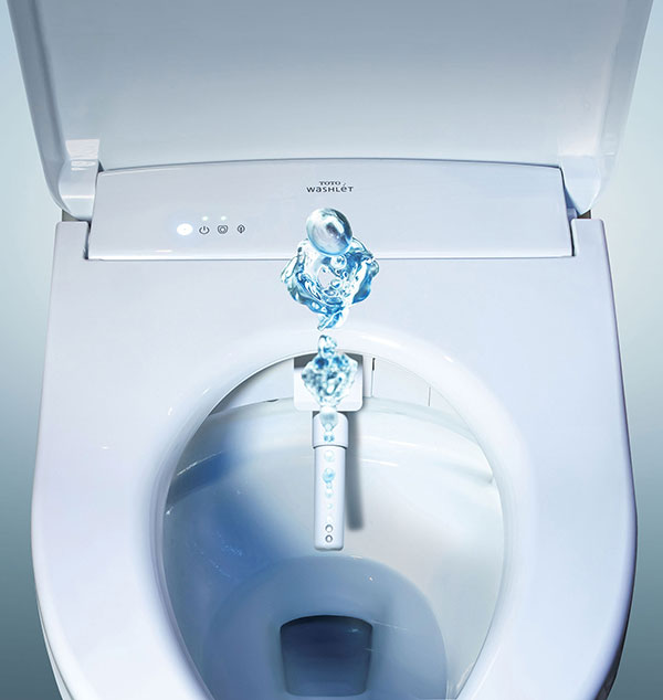 Top view of a TOTO WASHLET bidet seat with a self-cleaning wand spraying water, showcasing its advanced cleansing capability.