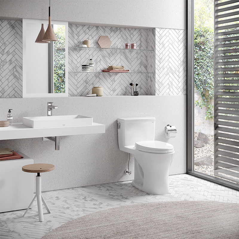 A TOTO UltraMax Dual Flush toilet is displayed in a modern bath space.