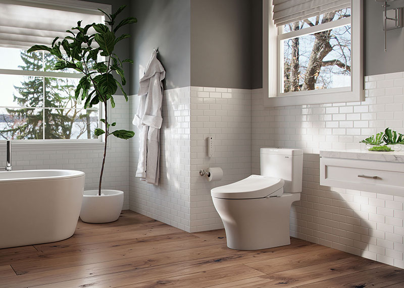 Modern bathroom with natural light and greenery showcasing a TOTO WASHLET K300 bidet seat and its chic design.